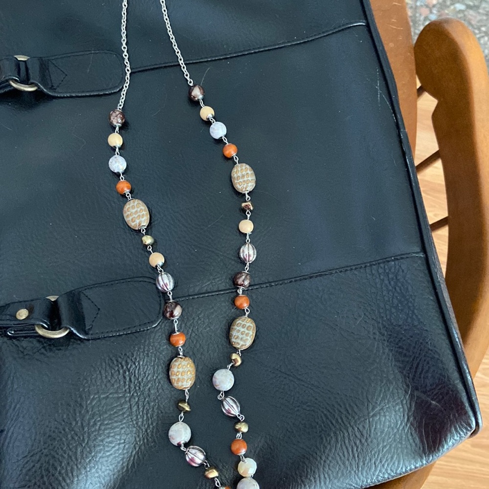 Long silver necklace with orange beads